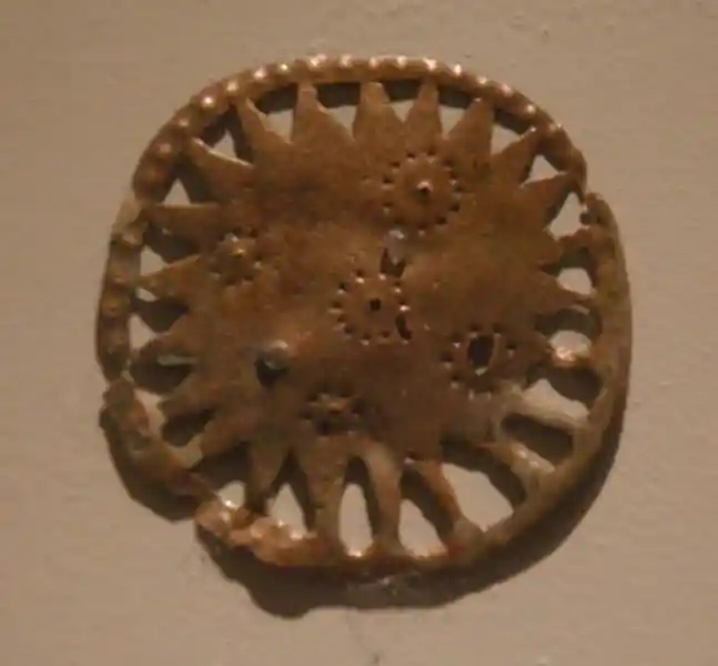 Bronze solar disc with circle dot forming a cross in the center